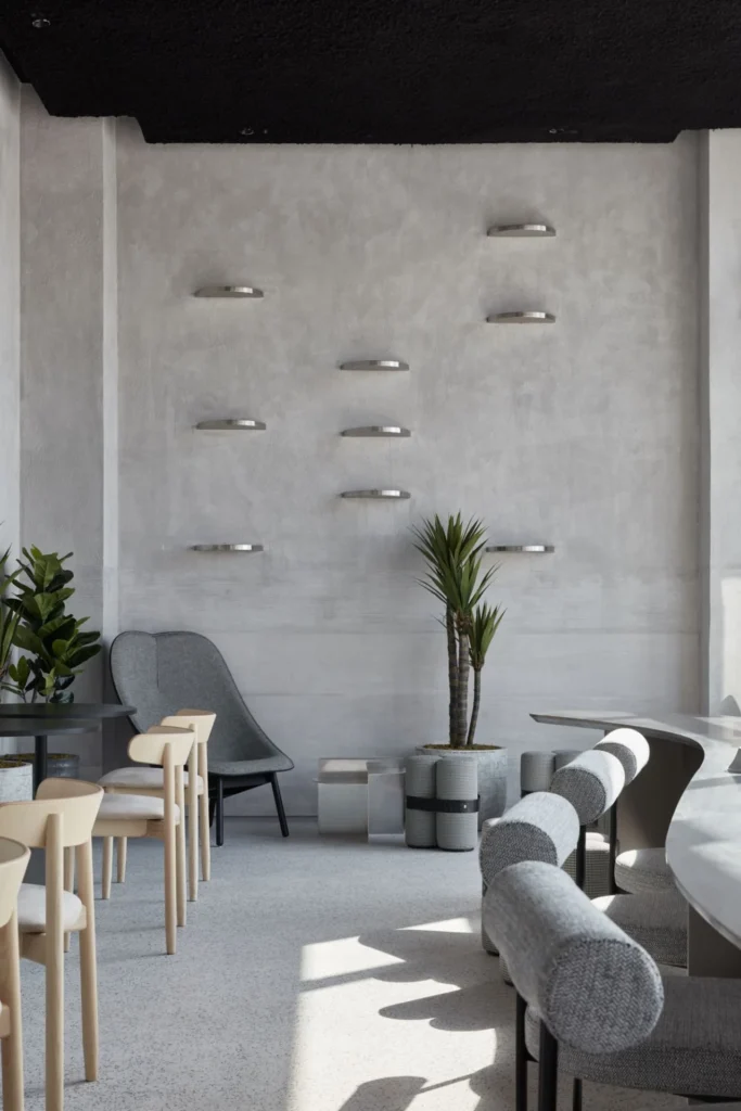 Hospitality fit-out featuring minimalist lounge seating, decorative wall elements, and modern cafe interior design.